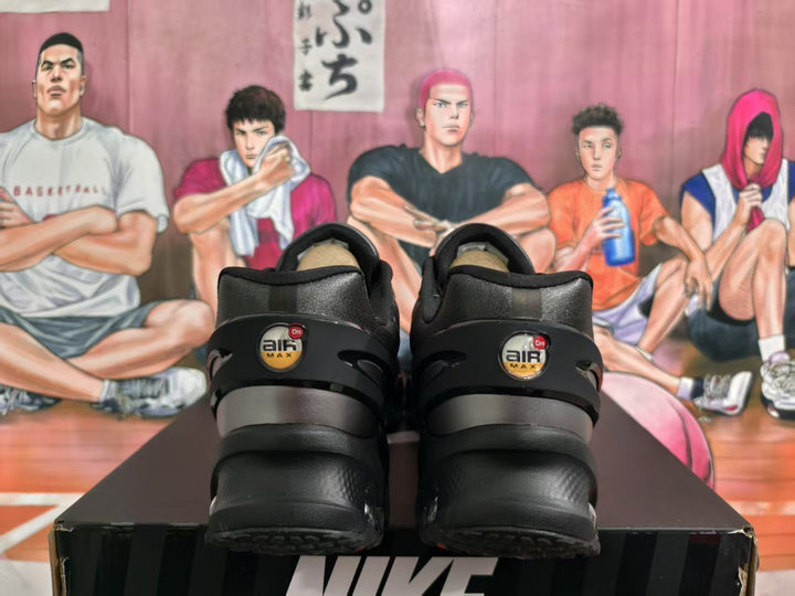 Rear view of black Nike sneakers with Air Max branding on the heels, displayed on a Nike shoebox.