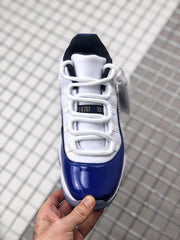 Top view showing white laces, white tongue, black collar lining, and blue toe overlay.