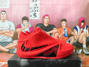 Red high-cut basketball shoe with black side accents, shown in profile