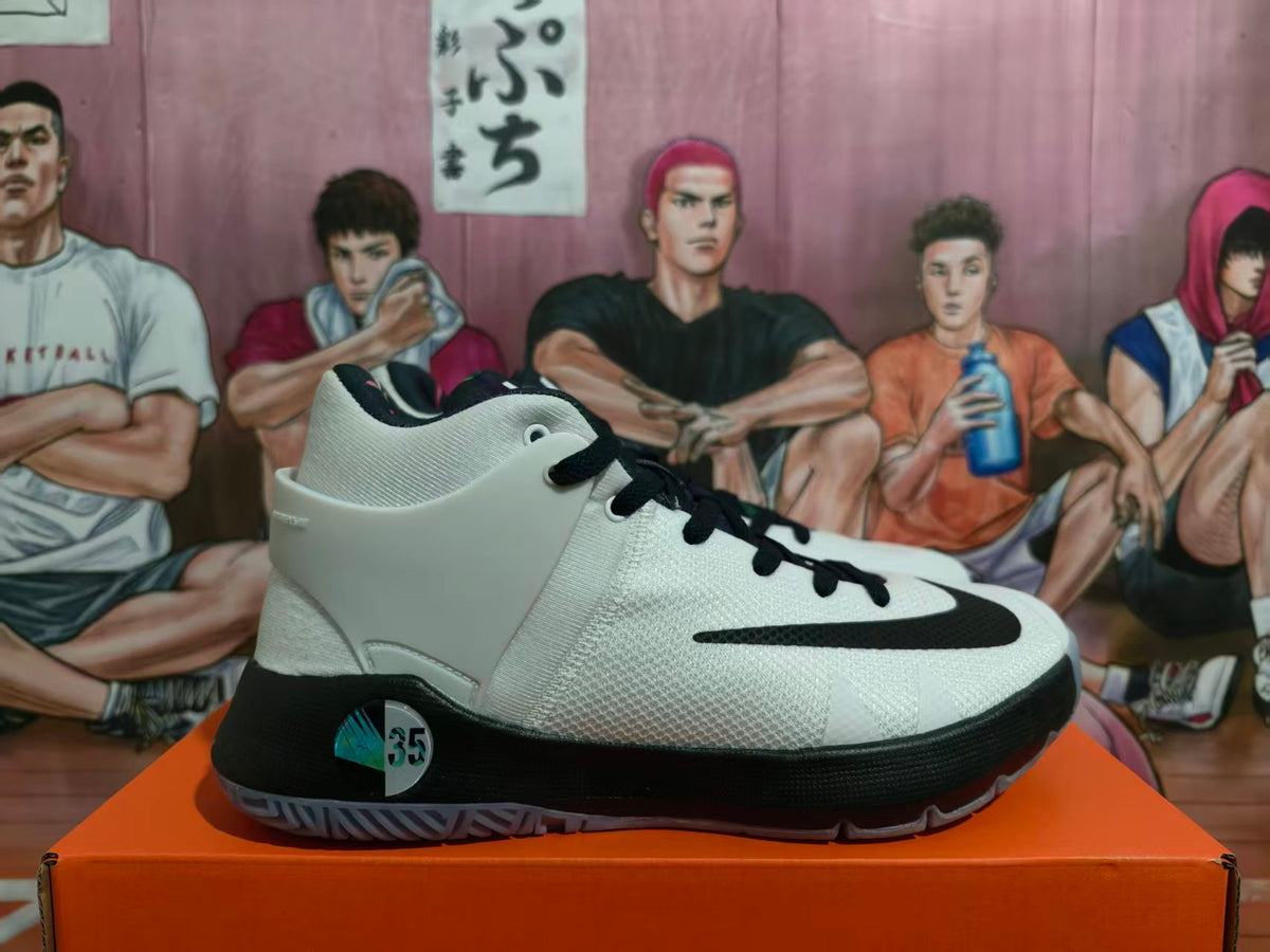 Side view of white and black Nike KD basketball shoes with a high-cut collar and patterned translucent outsole.