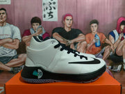 Side view of white and black Nike KD basketball shoes with a high-cut collar and patterned translucent outsole.
