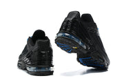 Rear and outsole views of black Nike Air Max Plus sneakers with blue accents.