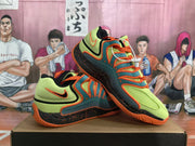 Angled side view of Nike basketball shoes in lime green, teal, orange and black