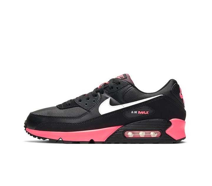 Side view of black Nike Air Max 90 sneakers with a white Swoosh and pink accents.