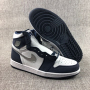 Sneakers shown from the side and outsole, displaying the dark patterned rubber tread.