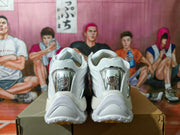 Rear view of white sneakers with silver-tone heel accents