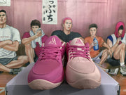 Front view of pink mismatched Nike sneakers with contrasting uppers, matching laces, textured toe boxes, and Nike tongue branding.