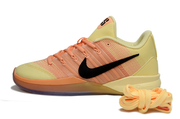 Profile of a yellow and orange Nike Sabrina 3 shoe