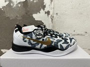 Side view of patterned Nike Kobe shoe with gold swoosh and white midsole