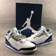 Front three-quarter view of the pair displayed with a dark Jordan-branded box in the background.