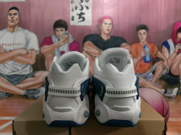 Rear view of white and navy Nike sneakers showing padded collars, mesh heel panels, and contrasting heel straps.