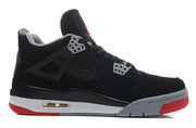 Side profile showing the black upper, grey lace supports, mesh panel and red outsole.