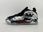 Black high-top sneaker with silver, white, and gray camouflage graphics.