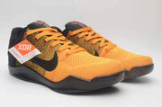 Pair of orange and black Nike Kobe 11 shoes with orange laces