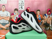 Pair of white, black, and red Jordan basketball shoes shown from the side
