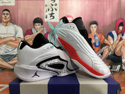Angled view of the basketball shoes showing the side profile and red outsole accents