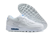 White Nike Air Max 90 sneakers shown from the side and outsole.