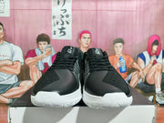 Front view of black lace-up basketball shoes with white outsoles