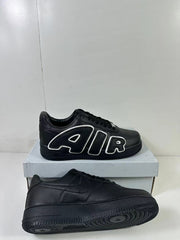 Black low-top sneakers shown from side and outsole angles, with one pair displaying AIR lettering and a circular-groove sole.