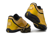 Yellow and black Nike LeBron 23 basketball shoes shown from the rear with black and gold laces.