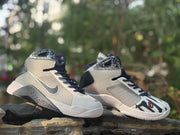 Two Nike HD2008 high-top sneakers displayed together, including the number 10 toe detail.