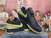 Pair of navy and yellow basketball shoes shown from an angled side view