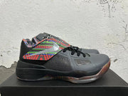 Side view showing the multicolor patterned panel, dark mesh-like section, and black midsole.