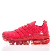 Side profile of a red Nike sneaker with a translucent segmented sole.