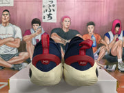 Rear view of navy blue basketball sneakers with red heel pull tabs and cream-colored midsoles.