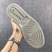 Underside view showing the light-colored rubber outsole with circular traction grooves.