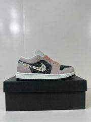 Side profile of one low-top sneaker with pink, violet, sail, and black detailing.