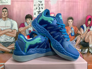 Pair of blue Puma basketball sneakers with mint-green branding displayed on a box.