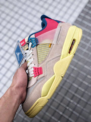 Close side view showing the translucent pink wing panel, cream overlays, and yellow midsole.