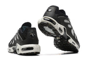 Rear and outsole views showing visible cushioning windows and speckled midsole
