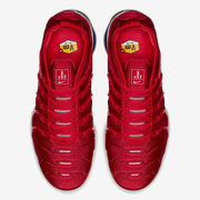 Top view of the red sneakers showing laces and Air VaporMax Plus tongue labels.