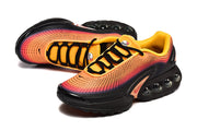 Angled view of the orange and pink Nike Air Max DN sneakers with black laces and sole.