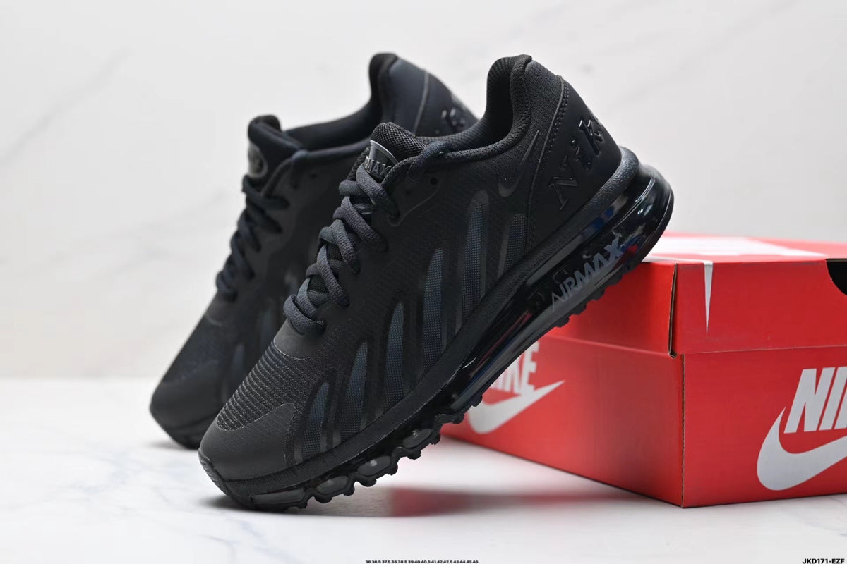 Pair of black Nike Air Max lace-up sneakers with tonal side detailing beside a red Nike shoe box.