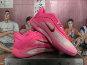 Angled view of the pink basketball shoes highlighting the side overlays, translucent panel, Swoosh, and sculpted sole.