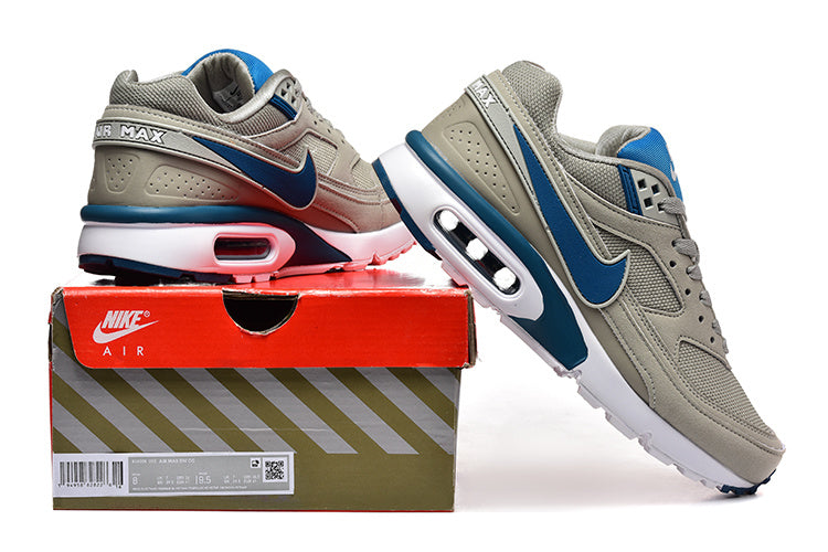 Gray and blue Nike Air Max sneakers displayed with a box; the box label shows a sample size.