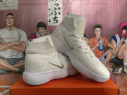 Angled view of white Nike high-top sneakers showing the textured upper and side Swoosh