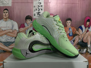 Angled view of the mint green Jordan basketball sneakers showing the lace-up upper, padded collar, layered side design, and green outsole.