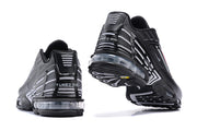Rear and outsole views of black Nike Air Max Plus sneakers showing the visible cushioning unit.