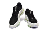 Front view of a pair of black and white Nike Pegasus Premium shoes with green outsole details.