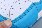 Magnified close-up of stitching along the blue overlay and white toe panel.