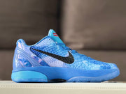 Side view of blue Nike Kobe 6 basketball shoes with black side branding and a textured upper.