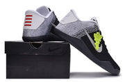 Black and white basketball shoes posed on a black box
