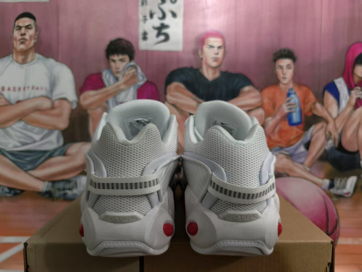Rear view of white Nike sneakers showing mesh collars, heel straps, and red sole accents.