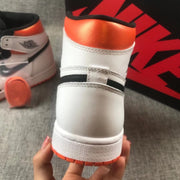 Close-up of the white heel, orange collar, black trim, and textured outsole.