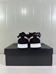 Rear view of the sneaker pair showing black heel panels, pink trim, and white midsoles.