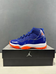 Side profile of a blue high-top sneaker with orange branding, white midsole, and orange outsole.